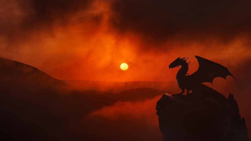 Chinesisches Horoskop 2024: Jahr des Drachen Drache auf einem Fels während eines Sonnenuntergangs