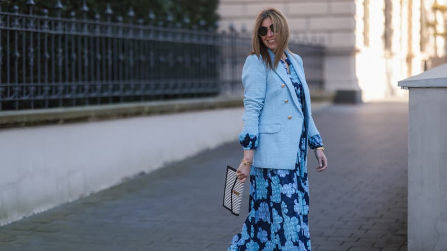 Wir verraten dir, welche Kleider für Hochzeitsgäste ab 50 Jahren besonders schmeichelhaft sind. Frau in hellblauem Kleid mit Blazer